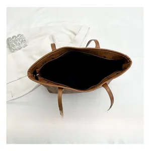 Top view of the spacious interior and zipper closure of this brown vintage tote bag