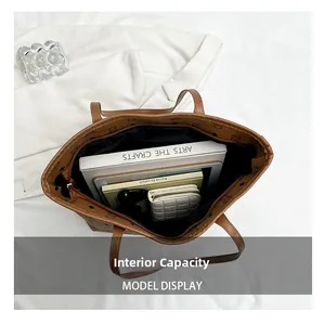 Top view of large brown tote bag showing internal storage for tablets and books