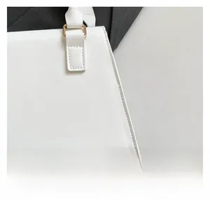 Detailed close-up of white quilted bag showing premium stitching and gold-tone hardware