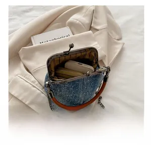 Internal view of denim crossbody bag showing capacity for a smartphone and wallet