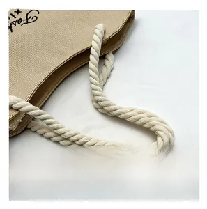 Detail view of khaki canvas tote bag featuring sturdy off-white cotton rope handles