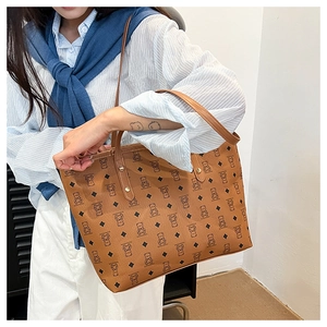 Close-up of brown tote bag showing bear print patterns and metal rivet details