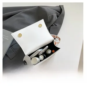 Internal view of a white leather crossbody bag showing large capacity for phone and cosmetics