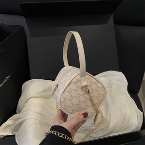 Fashionable cream cylindrical handbag with M-pattern print and gold chain strap