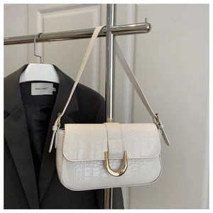 Detail of white crocodile pattern PU shoulder bag with elegant gold U-shaped metal buckle