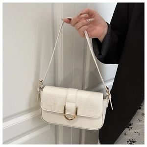 Detailed view of white crocodile pattern PU baguette bag with gold horseshoe buckle