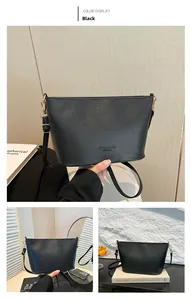 Détail du sac seau noir montrant la texture grainée et la boucle métallique dorée