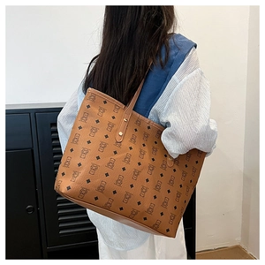 Detail view of large brown tote bag showing cartoon bear and diamond pattern textures