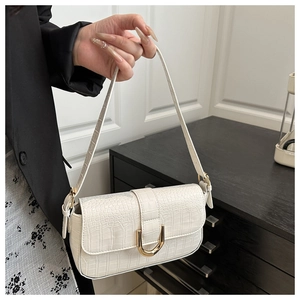 Detail of white crocodile pattern PU shoulder bag with elegant gold U-shaped metal buckle