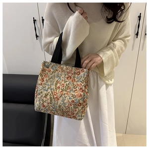 Detail of floral jacquard tote bag featuring vintage flower patterns and black handles