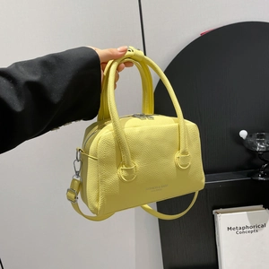 Minimalist yellow PU leather crossbody handbag with lychee texture and silver zipper detail
