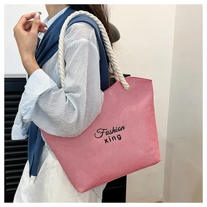 Detail of pink striped canvas tote bag with thick rope handles and fashion print