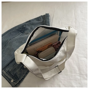 Top view of white nylon tote bag interior showing large capacity for tablet and books
