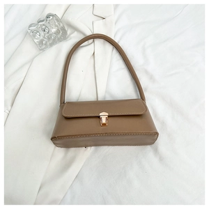 Macro detail of khaki baguette bag featuring a matte PU finish and golden metal buckle