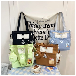 Detail view of multi-pocket canvas tote bags in four pastel colors with cute cloud patches