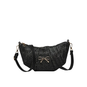 Fashionable black woven shoulder bag with golden butterfly buckle in a minimalist design