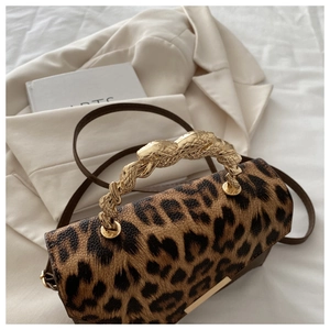 Detail showing leopard print texture and gold snake-shaped metal handle on small square bag
