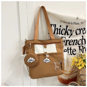 Detail of canvas tote bag with contrast panels, matching round pouch and clear card slot