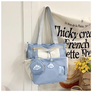 Detail view of canvas bucket bag with cloud-shaped embroidery and transparent pocket