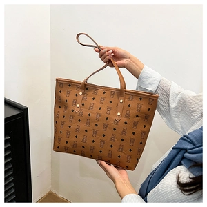 Detail of a large brown tote bag with cute bear and diamond pattern for daily commute