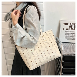 Detail of cute bear print tote bag with gold studs and slim leather shoulder straps