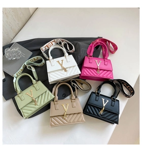 Flat lay of small crossbody bags in five colors with V-logo, tassels and wide straps