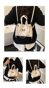 Three-way view of a cream bucket bag with pearl strap and silver butterfly buckle