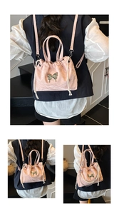Close-up of pink drawstring backpack with metallic butterfly and pearl chain strap