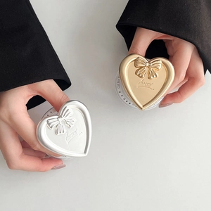 Detail of heart-shaped magnetic phone sockets with bow decor and happy lettering