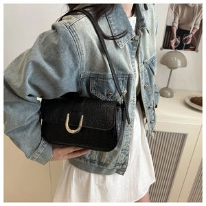 Detail of black crocodile texture PU leather underarm bag with gold U-shaped buckle