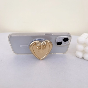 Golden heart phone grip with bow and 'happy' engraving on transparent case