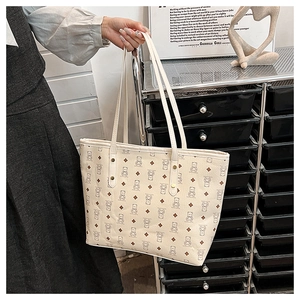 Detail of canvas tote bag featuring cute brown bear prints and sturdy shoulder straps