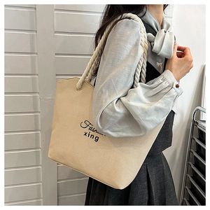 Cream beige canvas tote bag with thick rope handle and Fashion xing text on model