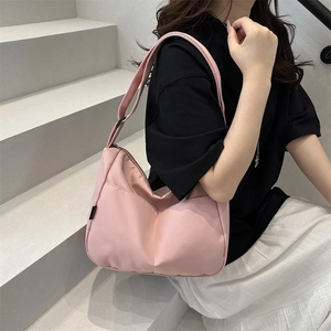 Pink waterproof nylon crossbody bag in a minimalist crescent shape for women