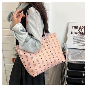 Pink tote bag detail with cartoon bear and diamond pattern, featuring a long shoulder strap