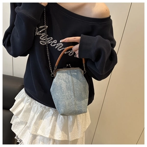 Detail of vintage denim mini bag with sparkling rhinestones and metal kiss-lock closure