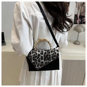 Detail of leopard print contrast shoulder bag with a unique gold rope metal handle