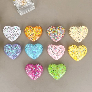 Colorful heart-shaped glitter phone grips in ten vibrant resin finishes for DIY phone cases