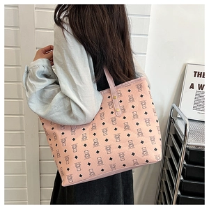 Model showing pink tote bag with cartoon bear pattern and spacious interior capacity
