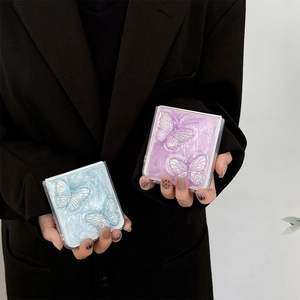 Detail of pearlescent butterfly phone cases for Samsung Z Flip 6 in blue and purple colors