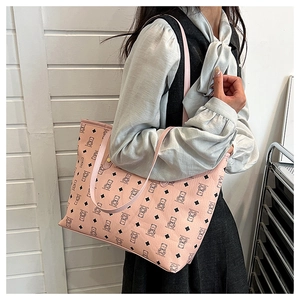 Detail view of pink tote bag featuring cute brown bear and black diamond pattern prints