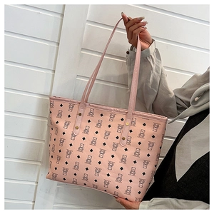 Detail of pink tote bag with bear print, PU leather texture and metal rivet reinforcement