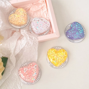 Close-up of heart-shaped glitter Magsafe phone grips in five vibrant pastel colors