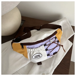 Close-up of retro color-block crossbody bag with adjustable strap and multiple zippers
