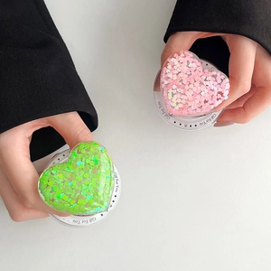 Detail of pink and green glitter heart phone grips with Gift For You engraving