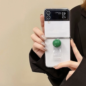 Transparent Samsung Galaxy Z Flip case with forest green decorative ball and ring handle