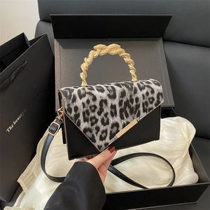 Fashionable leopard print crossbody bag with luxury gold snake handle and black leather base