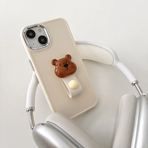 Detail of cream iPhone case with a 3D brown bear head and leather finger strap