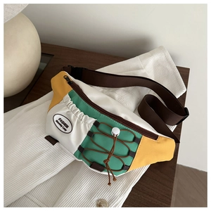 Detailed macro view of retro color-block crossbody bag fabric and fashion brand label