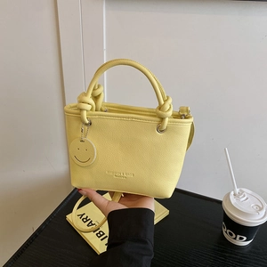 Pale yellow PU leather tote bag with smile pendant and Fashion & Bags text print